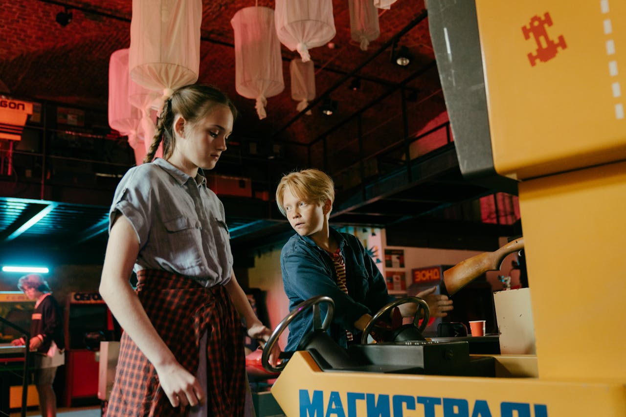 Teens enjoy a retro arcade game in a vibrant amusement center, capturing youthful excitement and nostalgia.